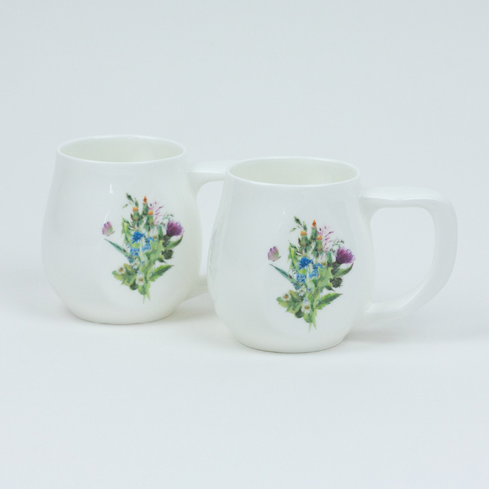 A pair of white fine bone china mugs with a colourful butterfly printed on the side.