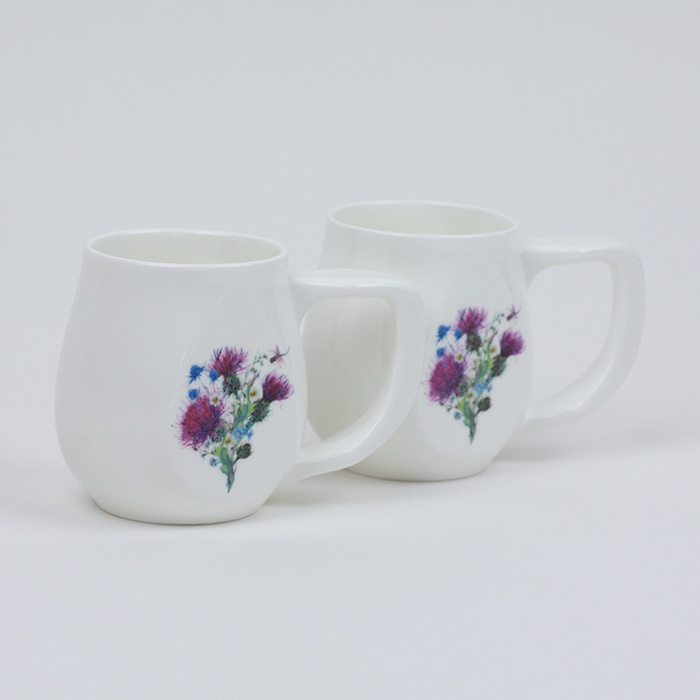 Two white fine bone china mugs with a colourful dragonfly printed on the side.
